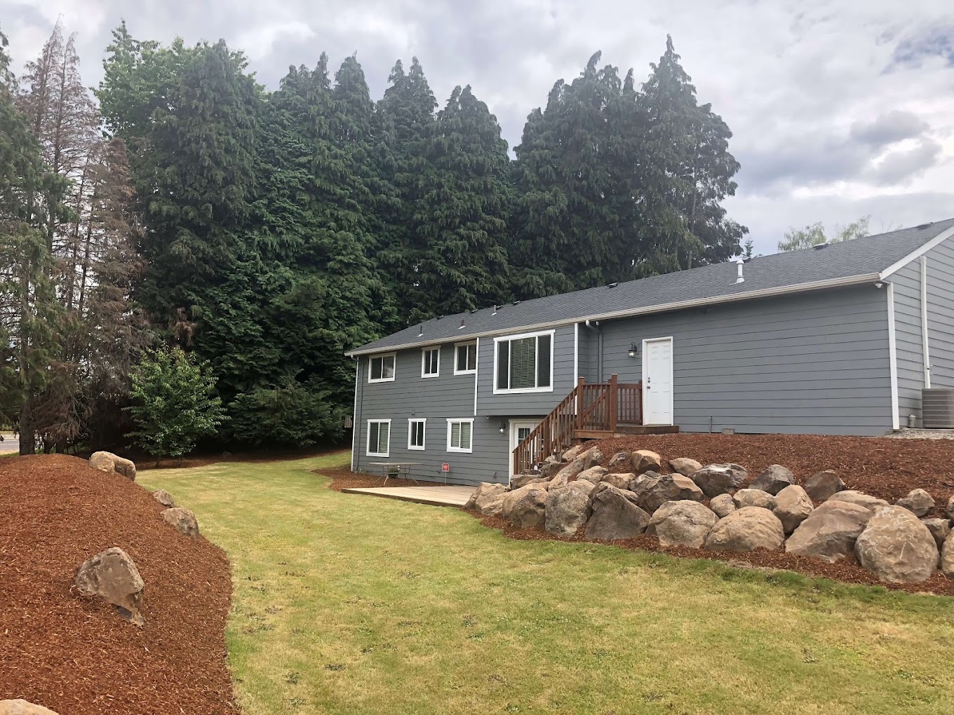Rehab center surrounded by trees and rock landscaping