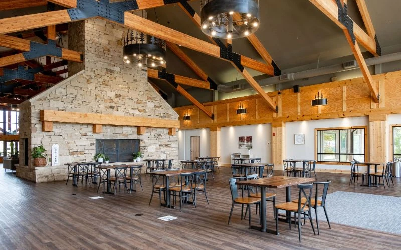 Wood-beam dining area with stone fireplace