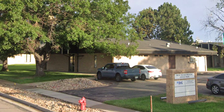 Brick medical office building with parking lot and trees