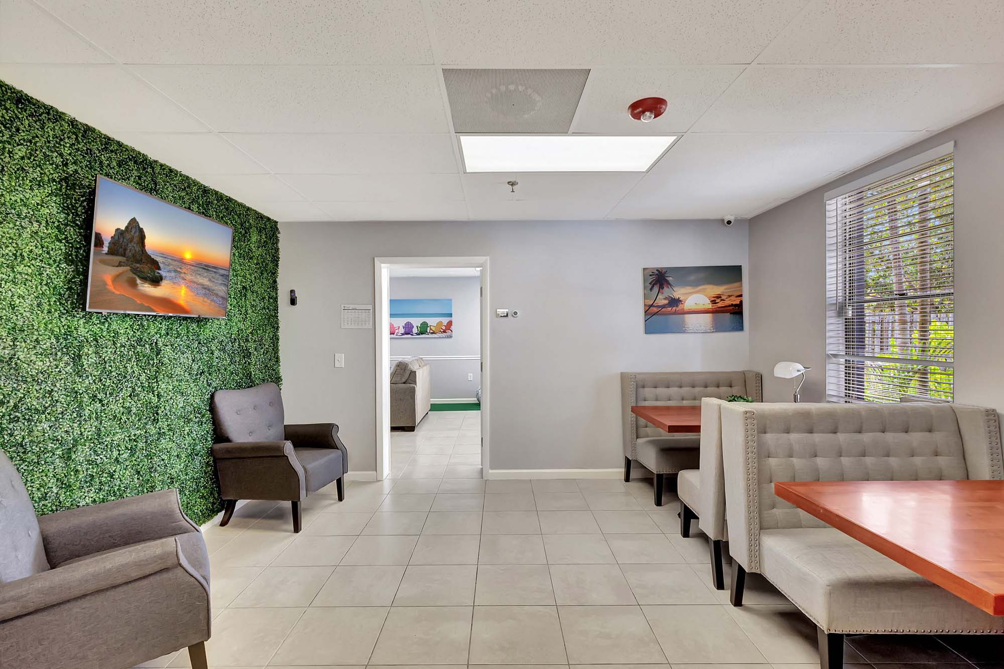 Dining area with booth seating and wall art