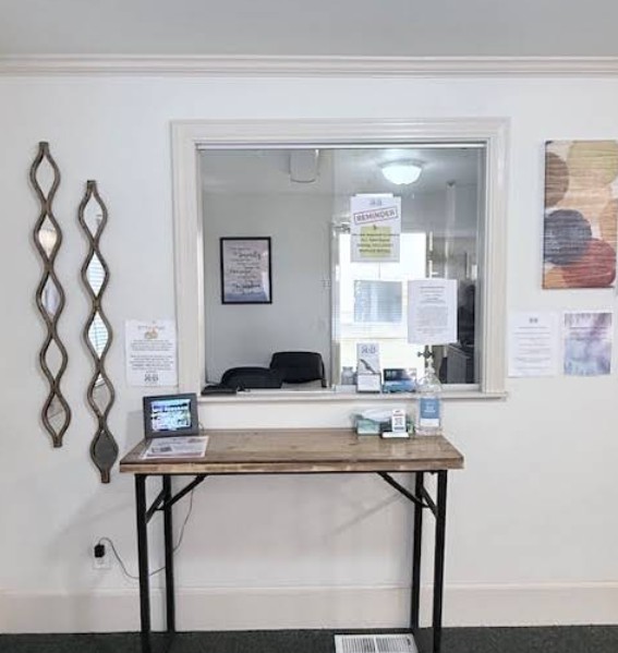 Reception counter with service window and seating area