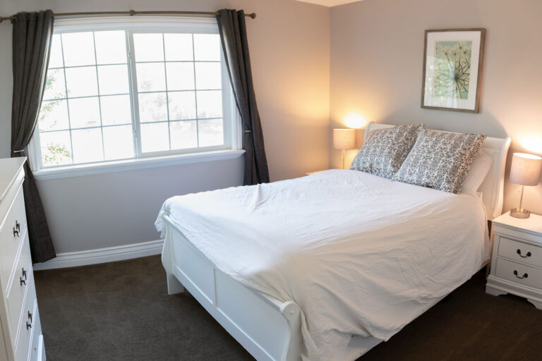Private bedroom with queen bed at Ascend Recovery