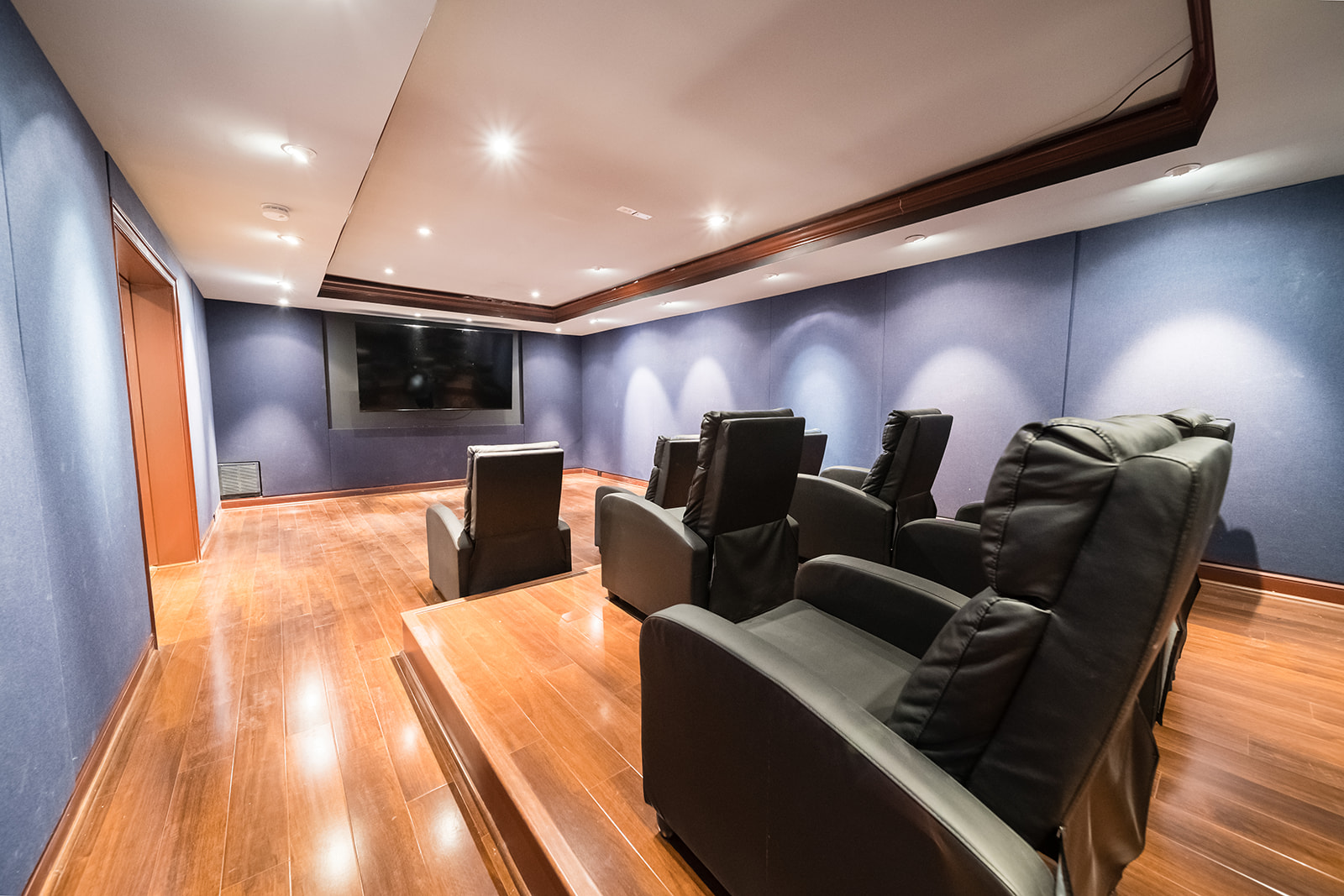 Home theater with leather chairs and large screen