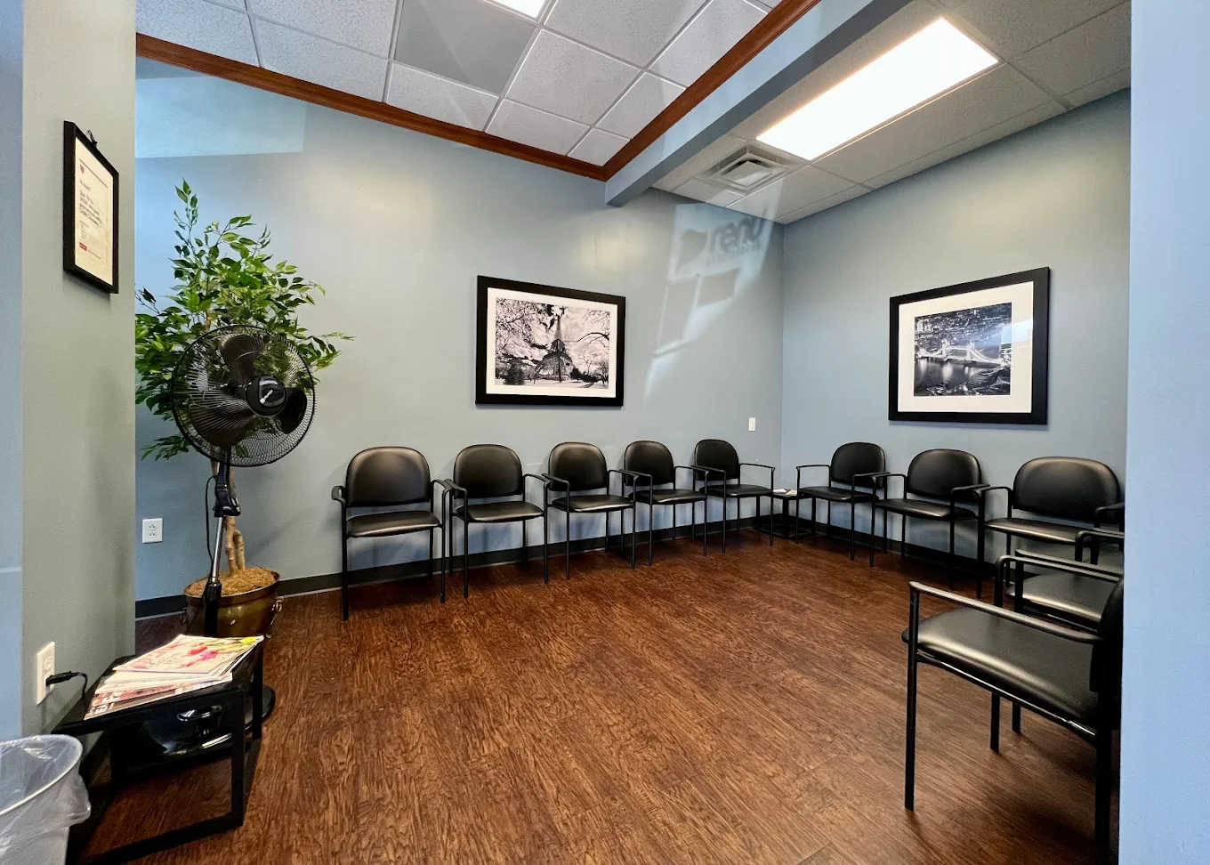 Waiting room with multiple chairs and wall art