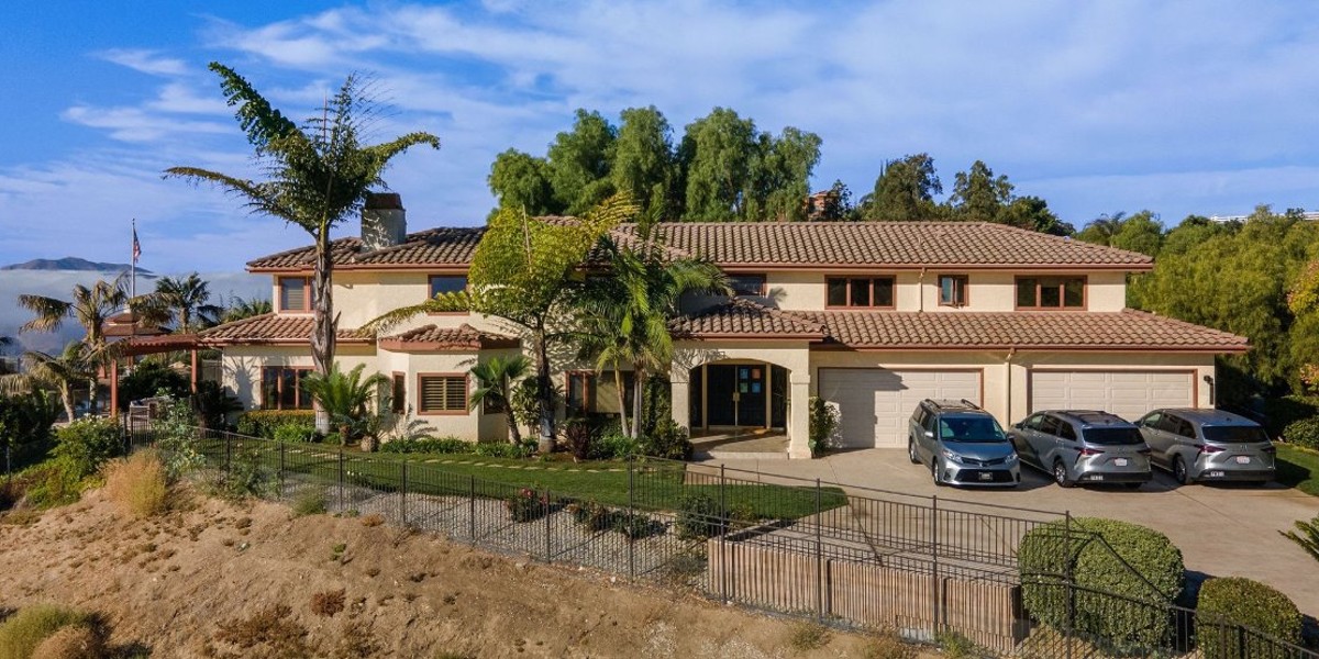 Large rehab facility with palm trees and driveway