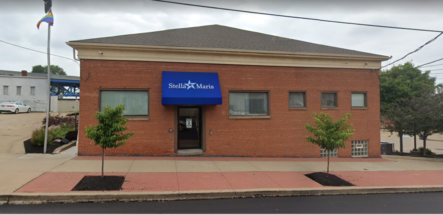 Front entrance with blue awning at Stella Maris Madden Center