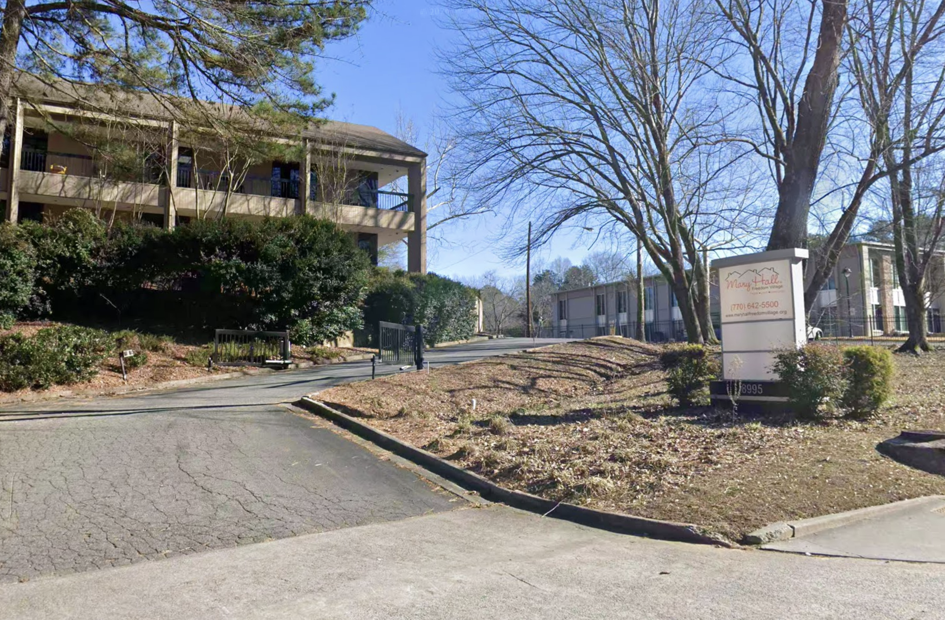 Two-story building with landscaped grounds and curved driveway