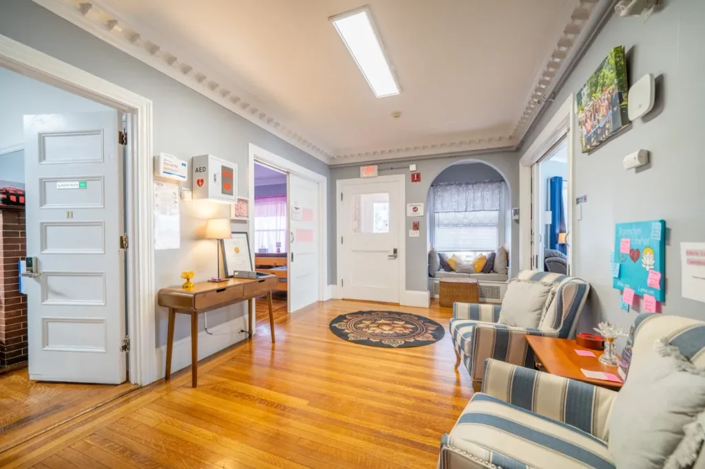 Shared lounge area with seating and hallway access