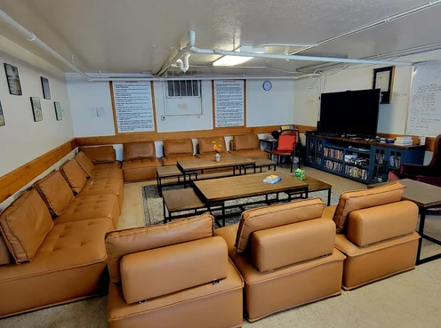 Large TV lounge with brown sectional seating