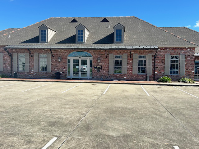 Front exterior of brick treatment center with parking area