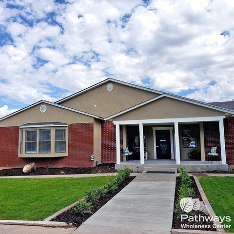 Exterior front view of Pathways Wholeness Center with landscaped lawn, walkway, and welcoming porch