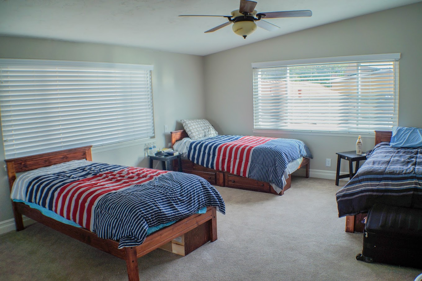 Shared bedroom with 3 beds and nightstands.