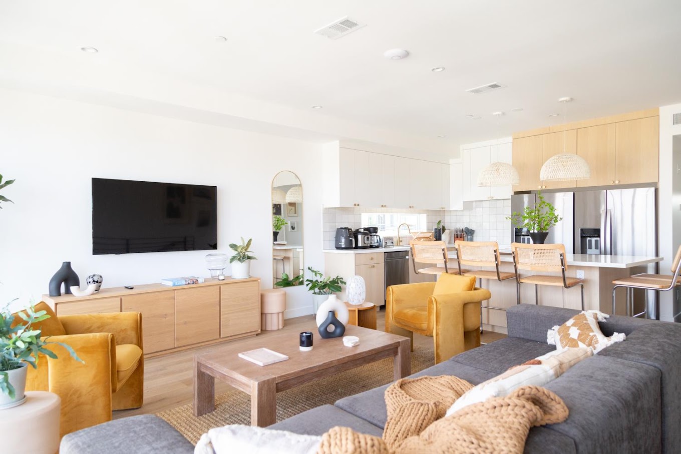 Open lounge with sofas, TV, and dining area