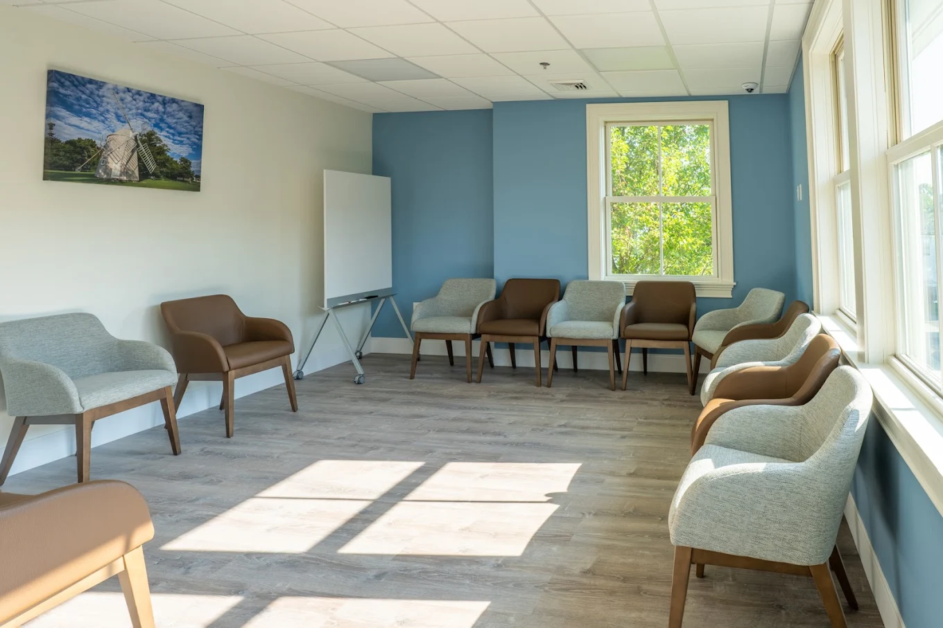 Bright group room with chairs arranged along windows