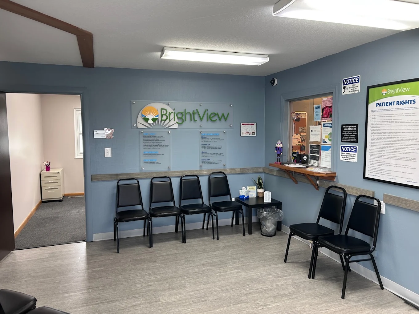 Waiting area with black chairs and BrightView wall sign