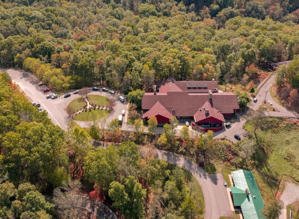 Aerial view of rehab facility with red-roofed buildings and greenery