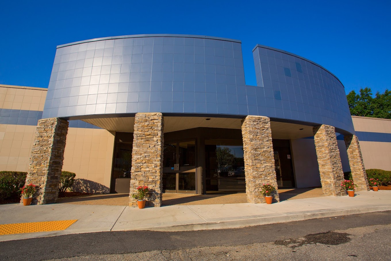 A building with stone columns at the entrance walkway.