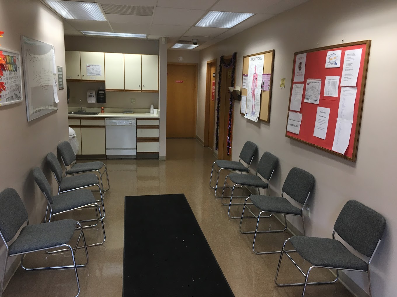 Waiting area with chairs along the wall.