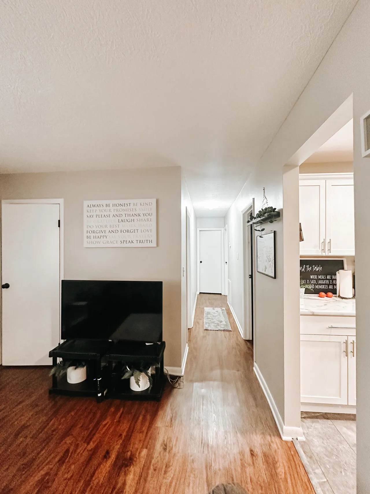 Hallway with wood flooring and doors leading to bedrooms