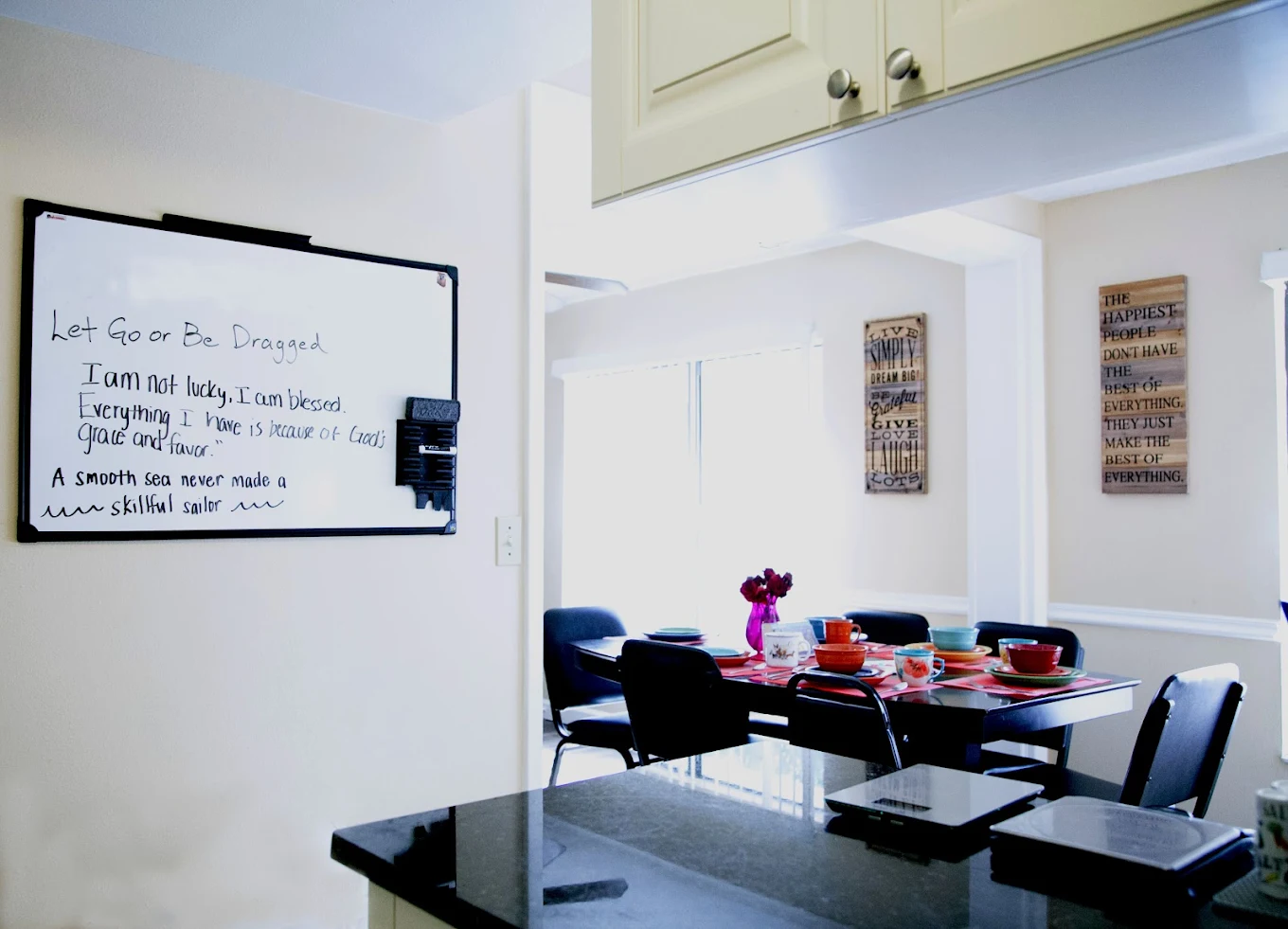 Dining table set with colorful dishes and flowers