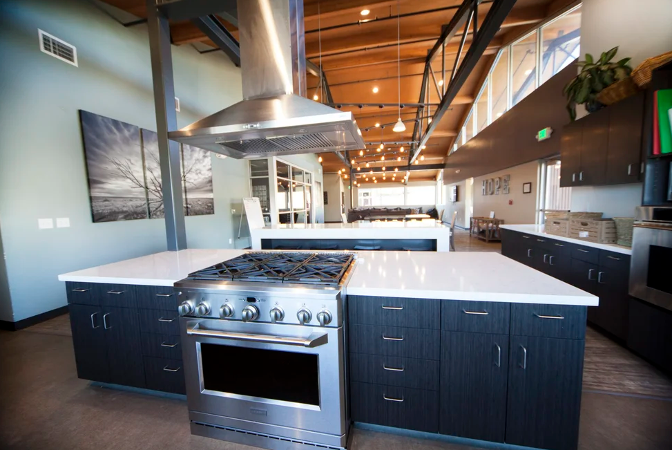 Shared kitchen with large island, stove, and open dining area