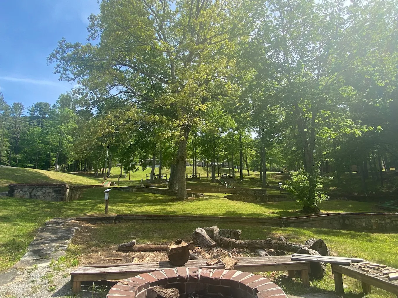 Wooded recovery center grounds with fire pit and stone landscaping