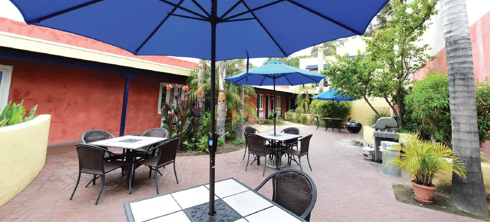Outdoor patio with umbrellas and tables at rehab center