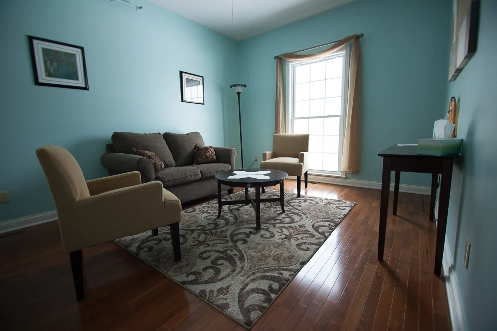 Comfortable group therapy room with seating and natural light