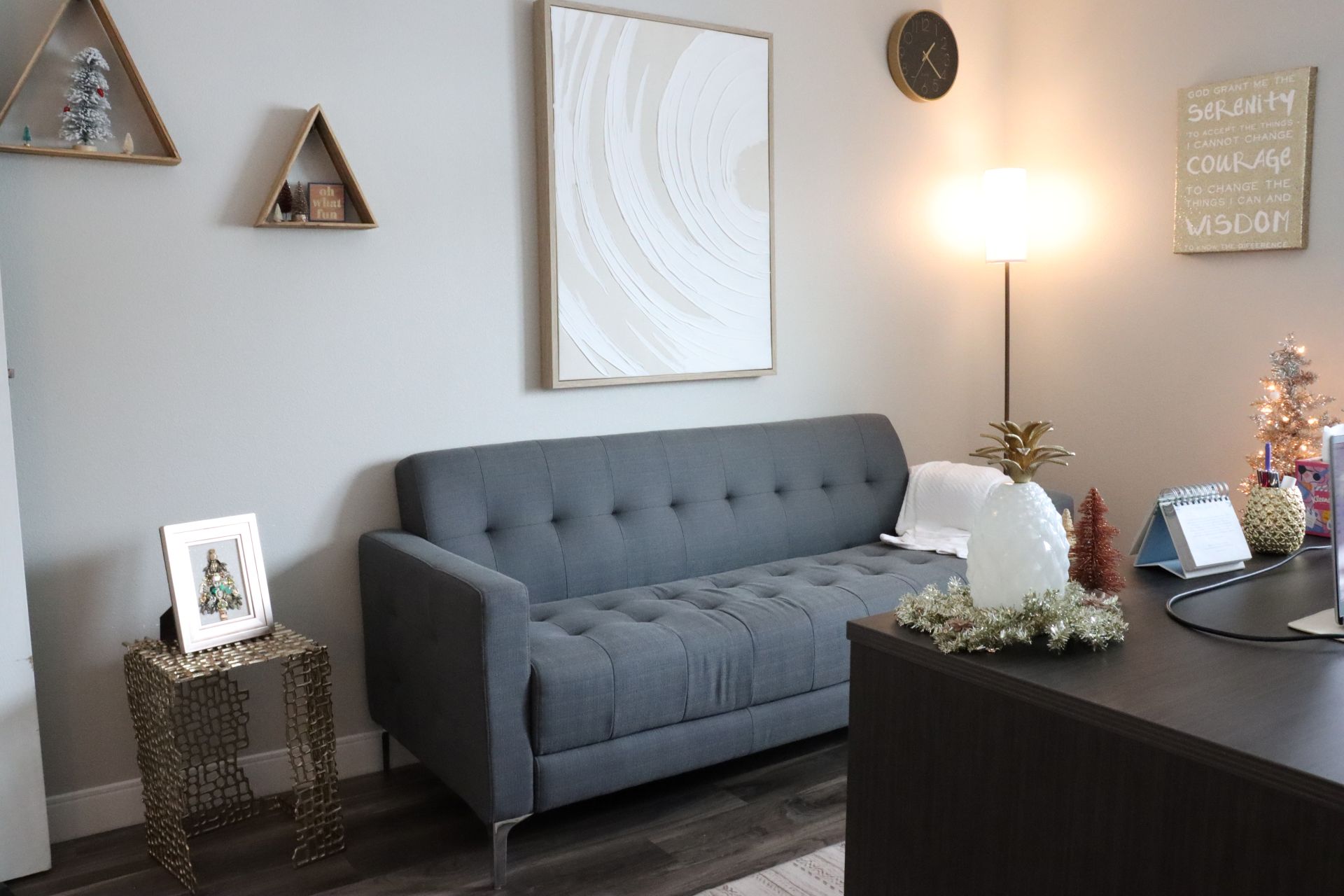 Office with desk, grey chair and paintings