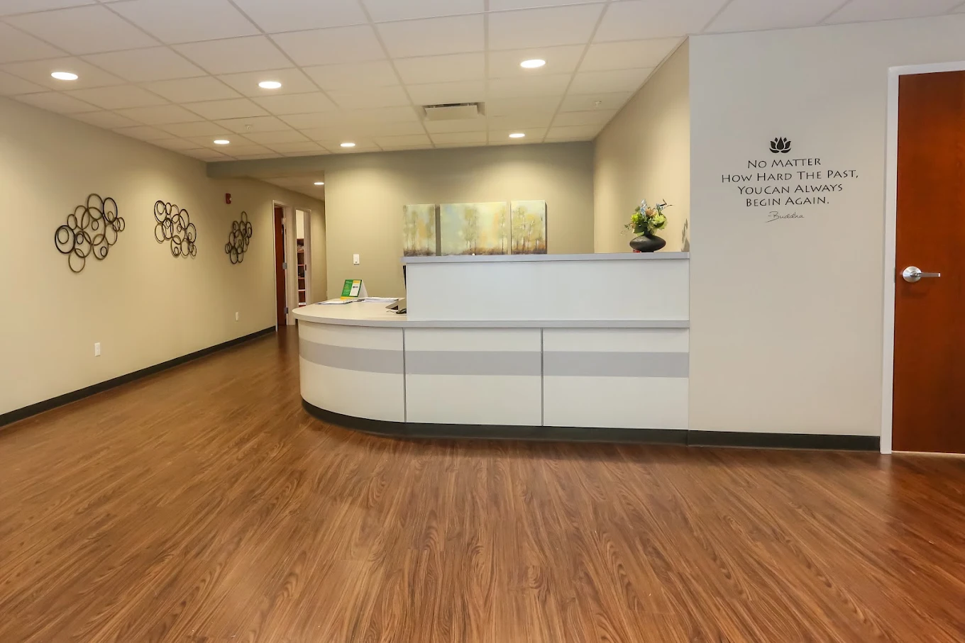 Curved white reception desk in a spacious entrance area