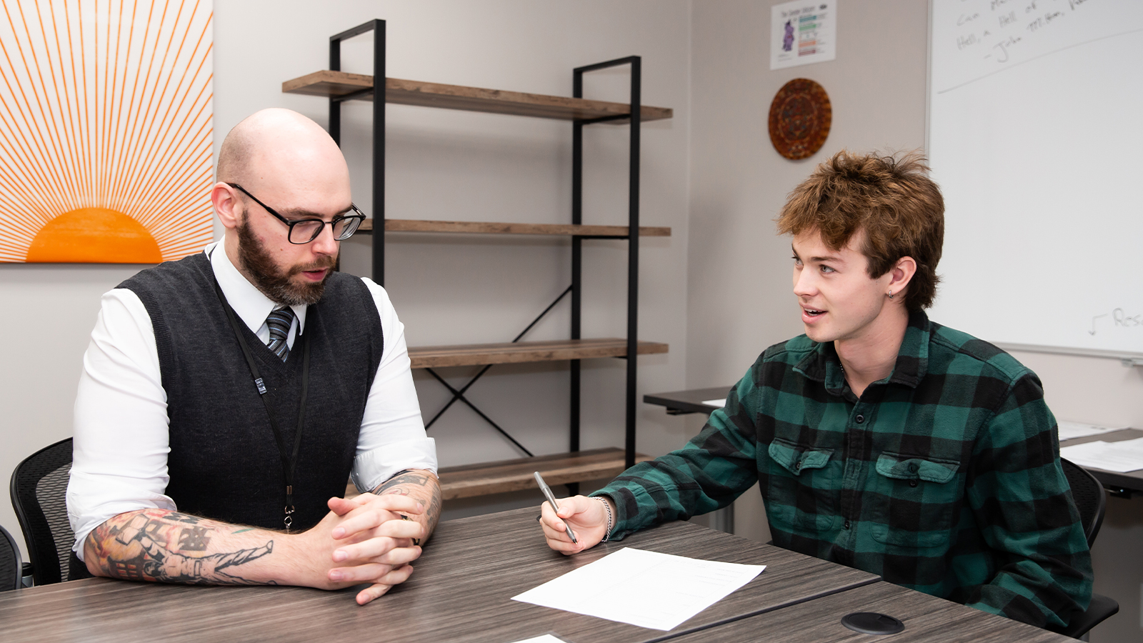 Common area with discussion at the table between two people.