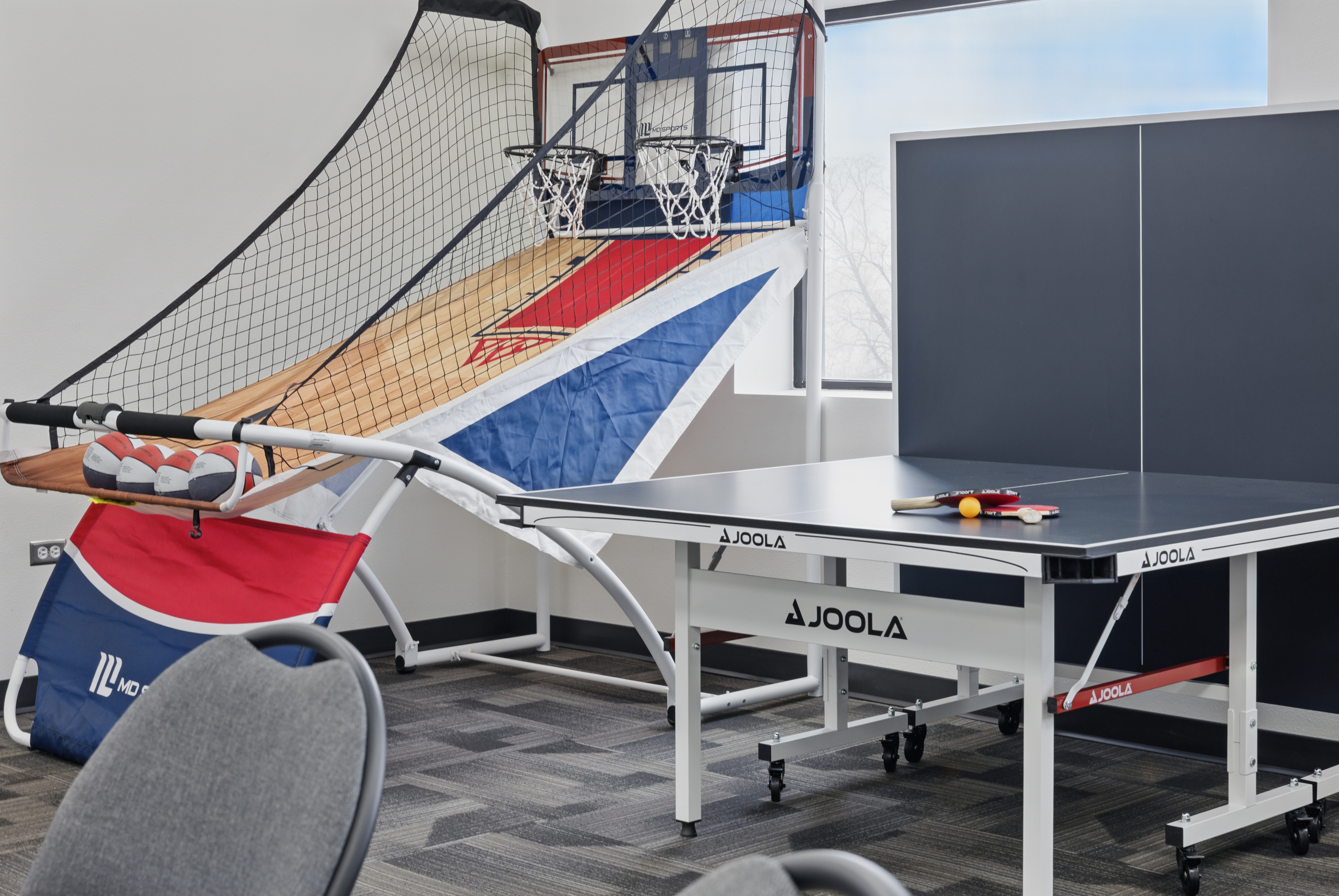 Game room with basketball hoop and ping pong table