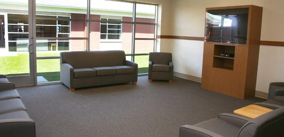 Lounge with couches, armchairs, and a TV cabinet