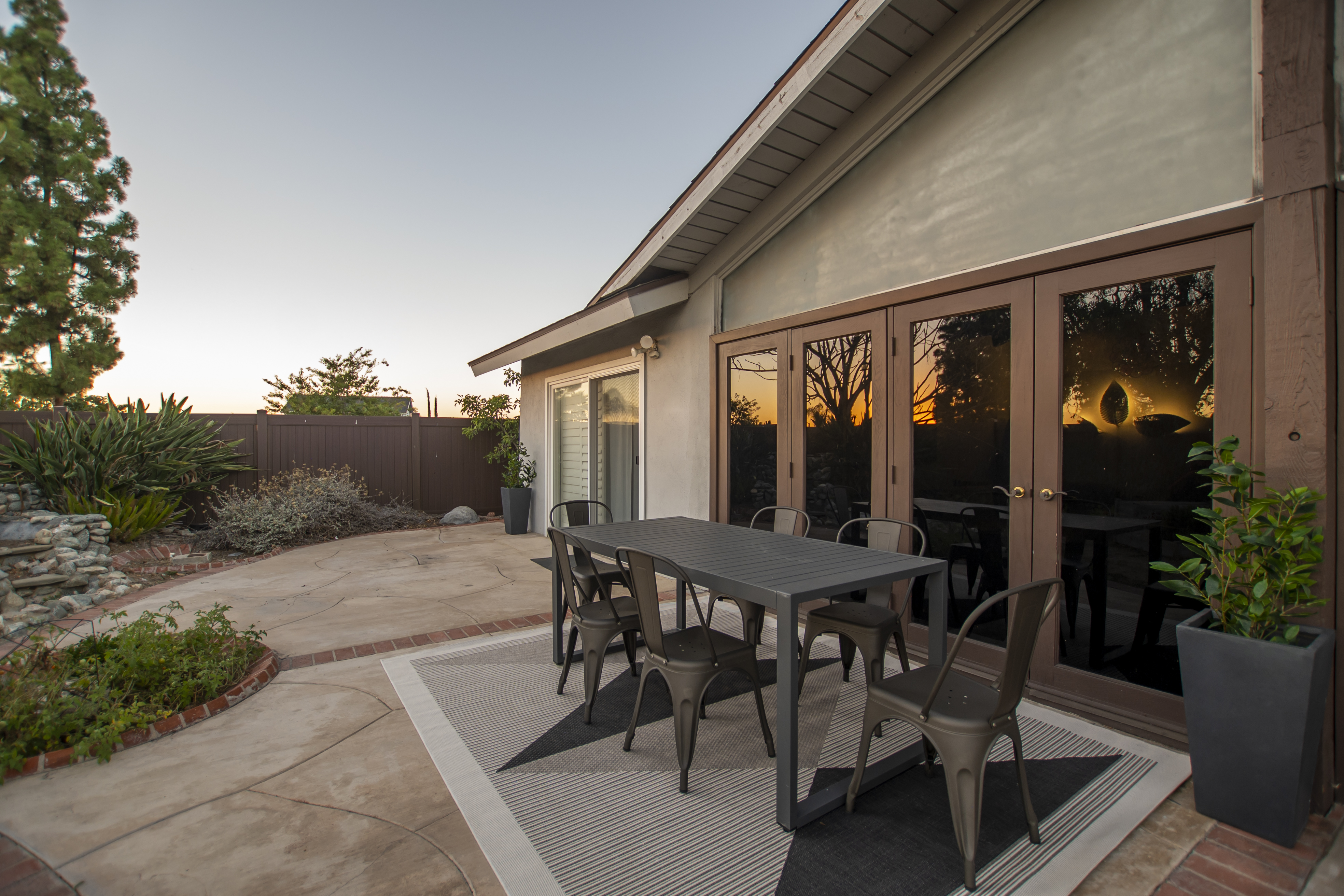 Outdoor patio with black chairs and sunset view