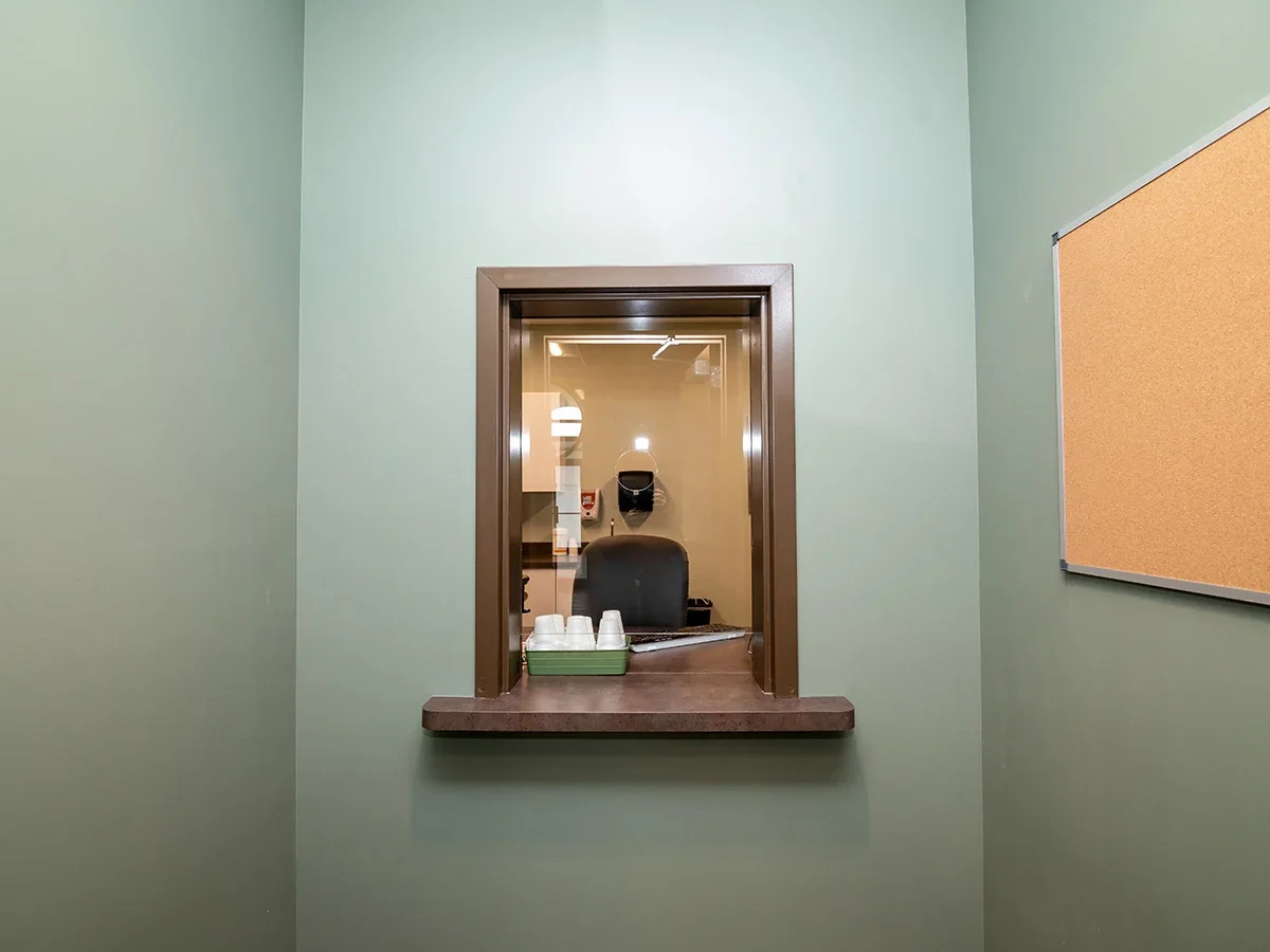 Small receiving window with counter and office chair