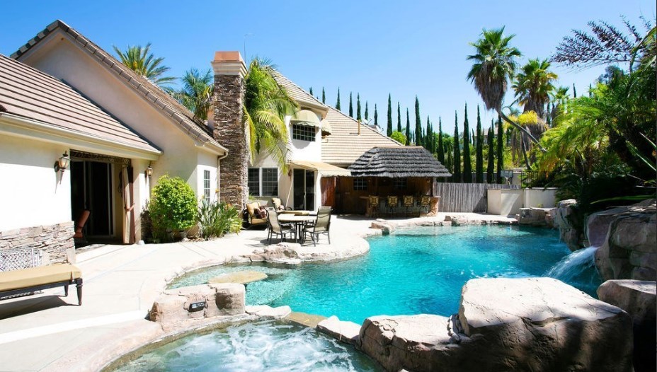 Backyard pool with seating.