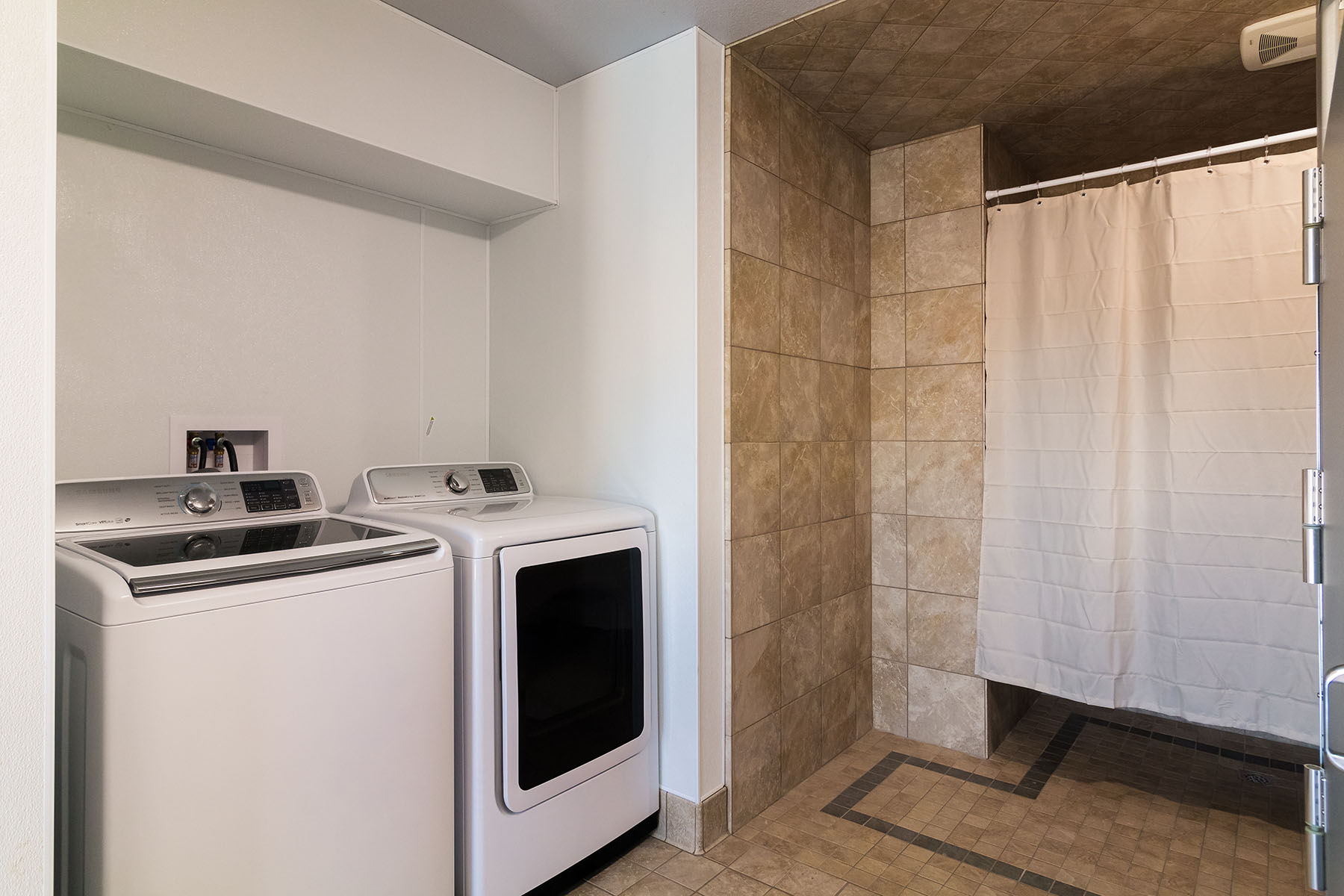 On-site laundry room with washer and dryer