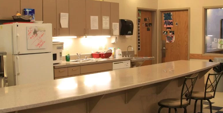 Kitchen with counter seating and wooden cabinets