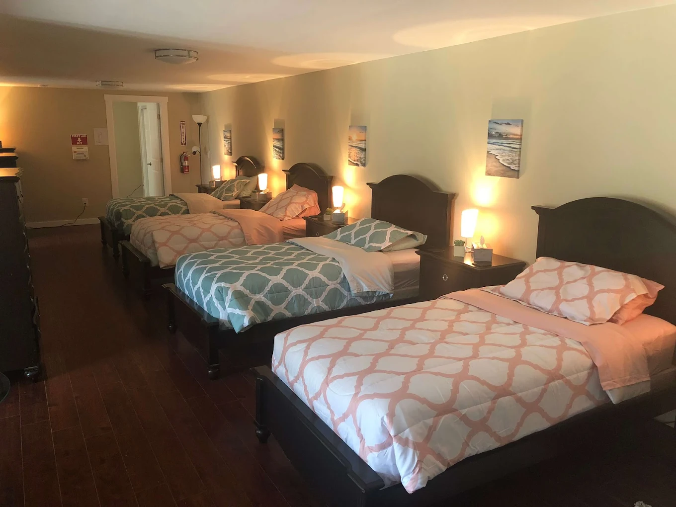 Room with four twin beds and pastel bedding