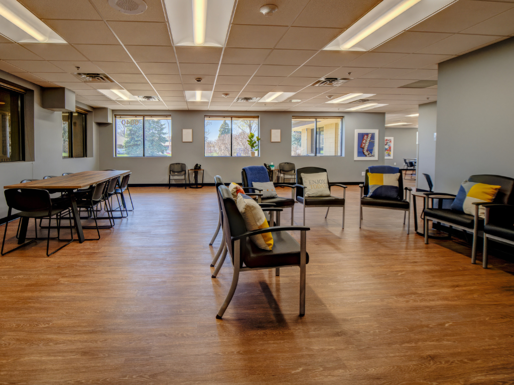 Large room with chairs, tables, and motivational artwork