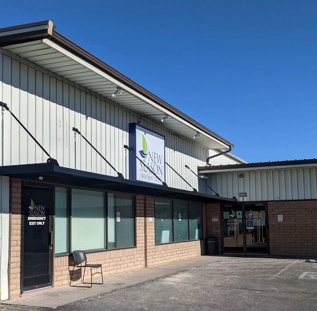 Exterior of New Season Treatment Center with signage and glass windows.