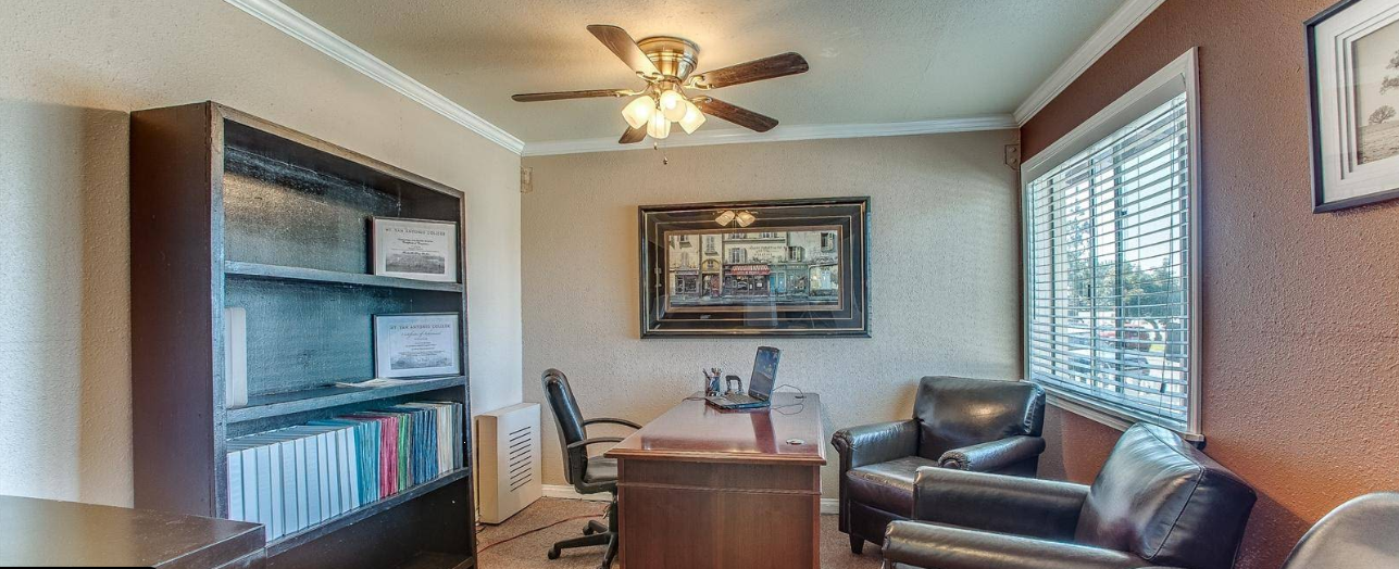 Office with desk, chairs, and bookshelf