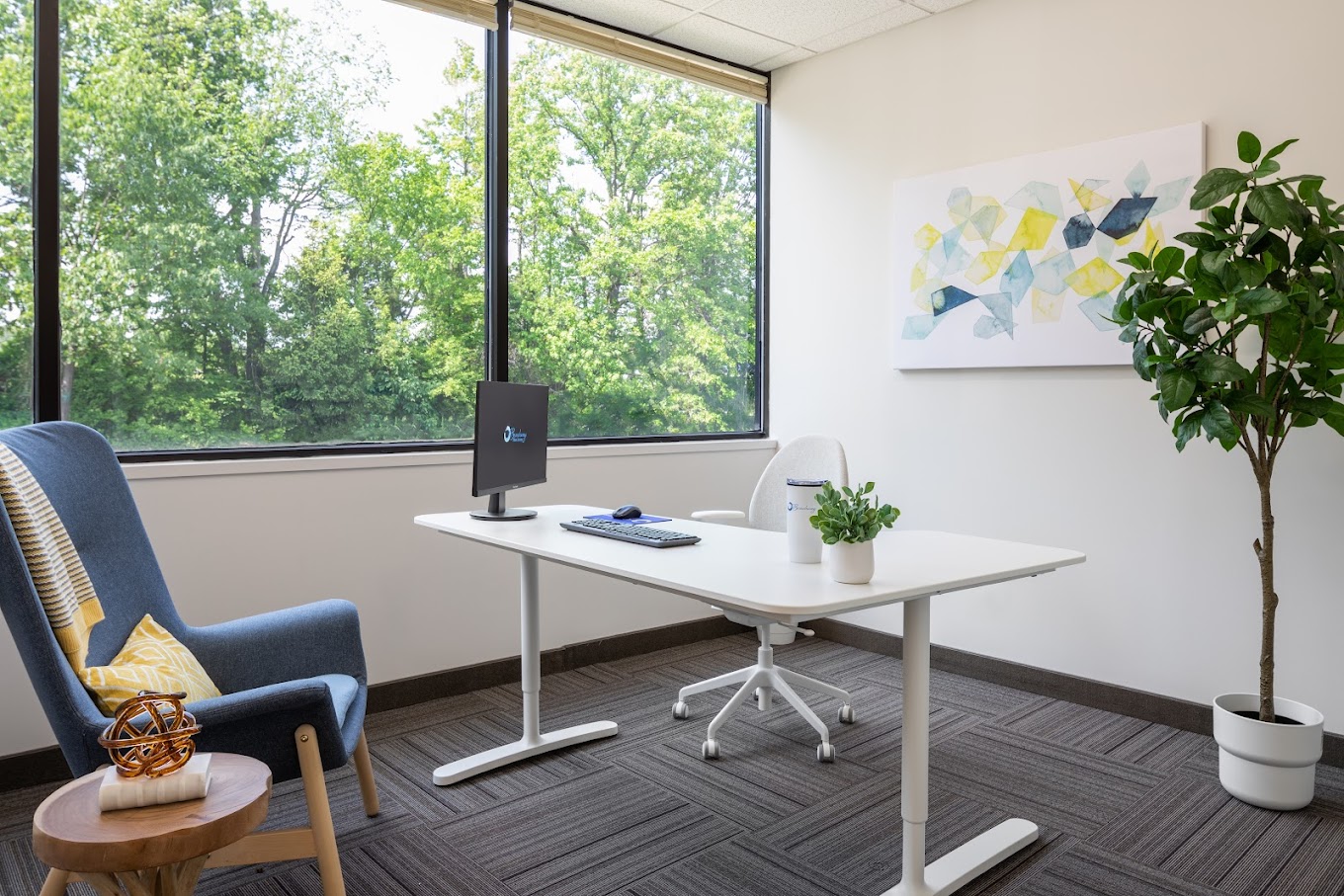 Office with a desk, chair, and decor.