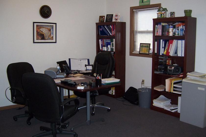 Rehab office with bookshelves and desk chairs