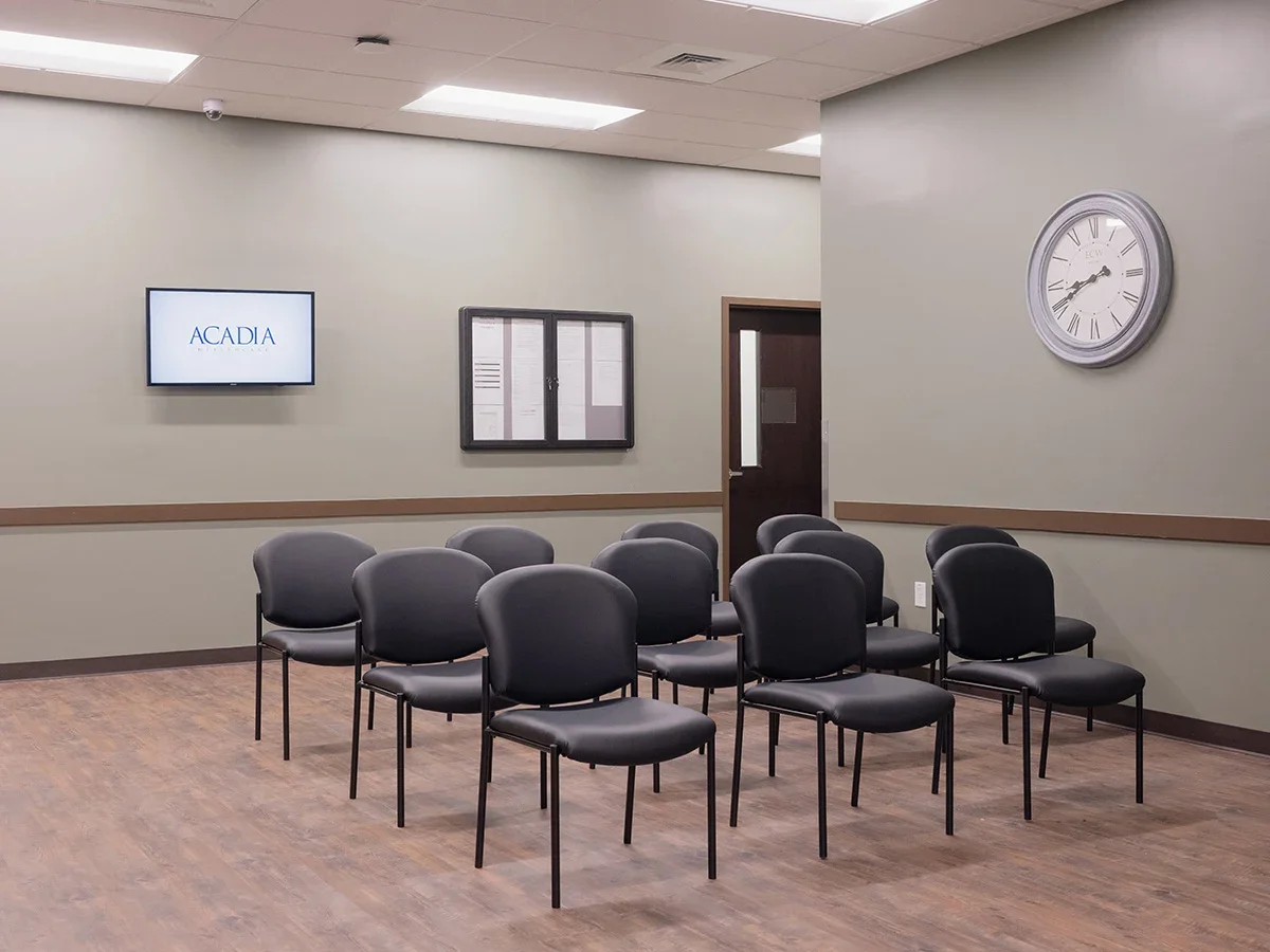 Waiting room with chairs and wall-mounted TV
