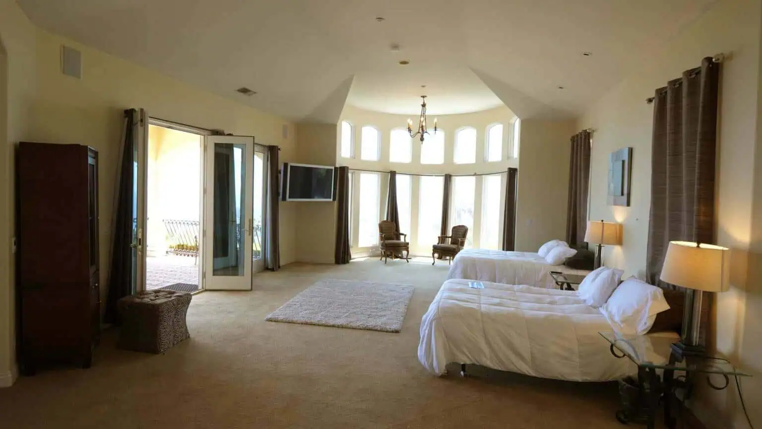 Shared bedroom with two beds and large windows