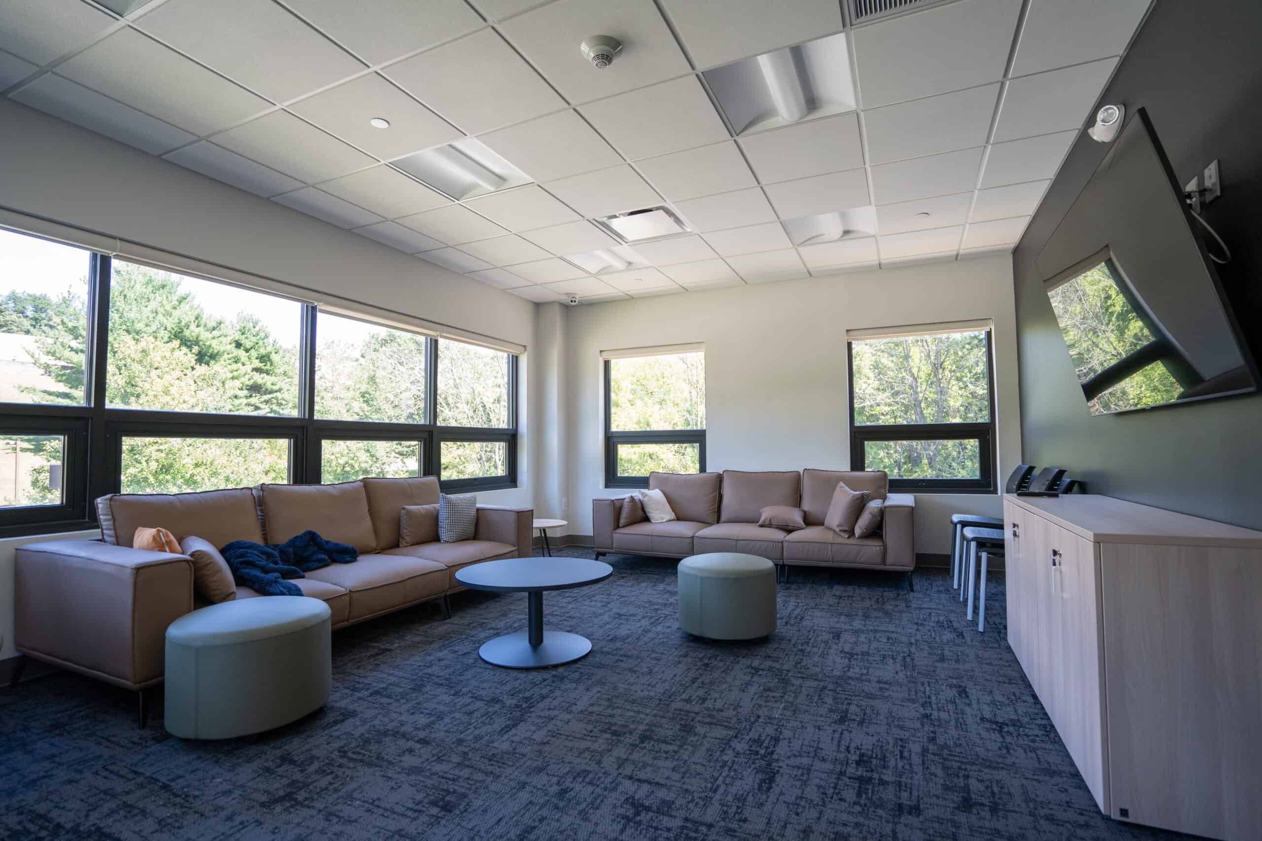 Spacious lounge with sofas and wall-mounted TV