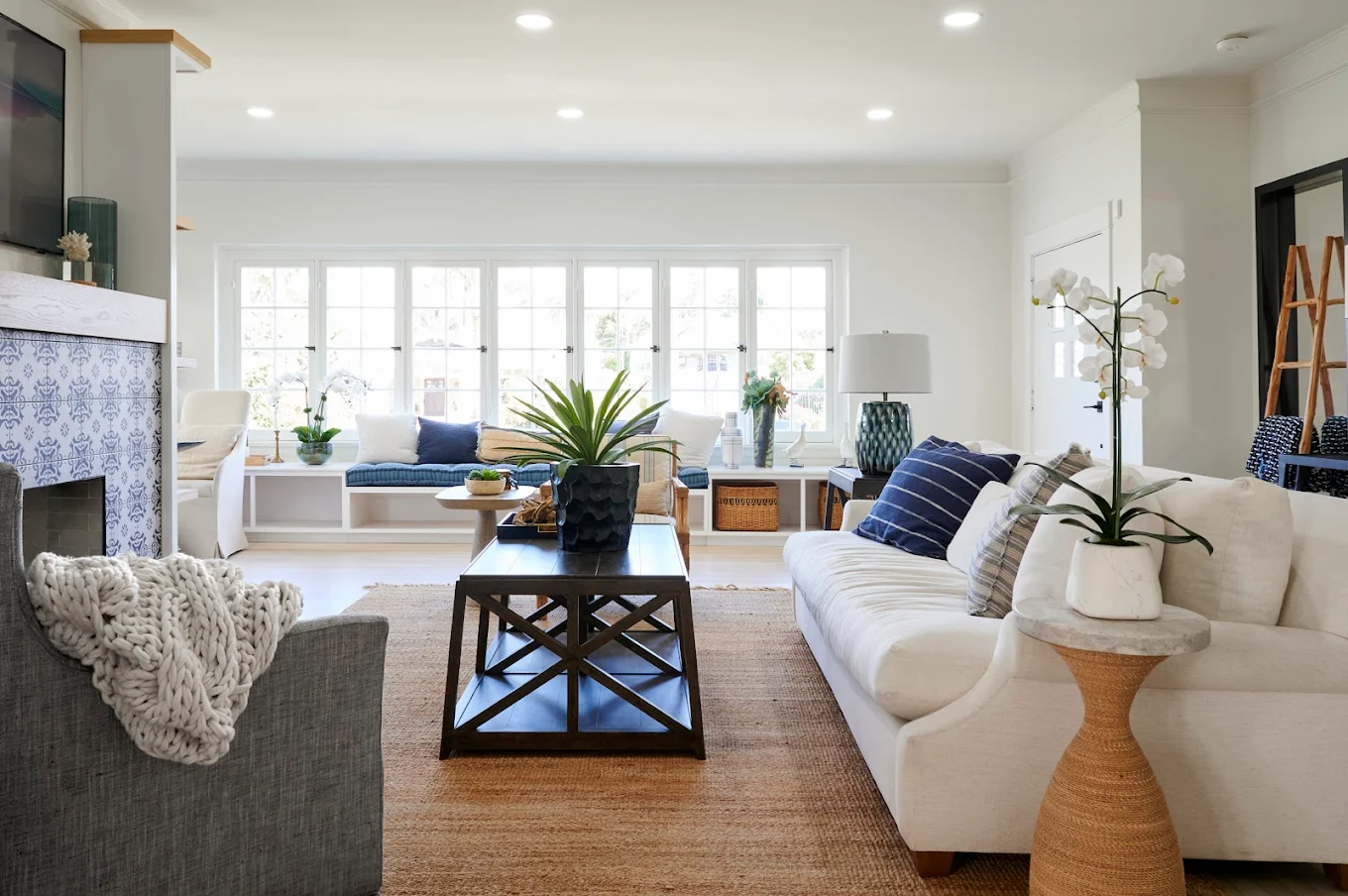 Spacious living area with white sofas and blue accents