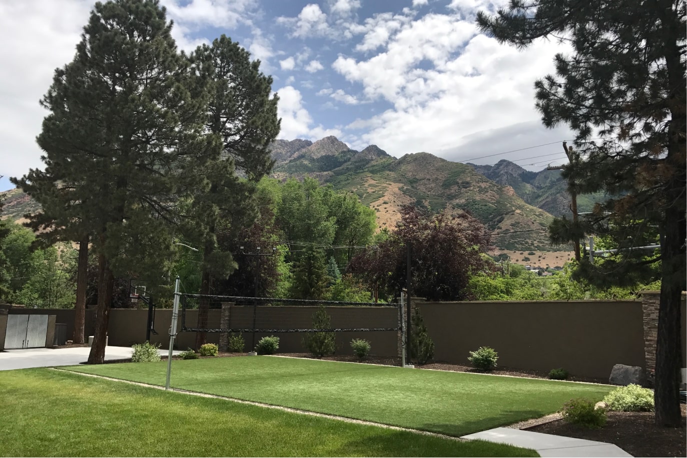 Volleyball court on grass with mountain backdrop