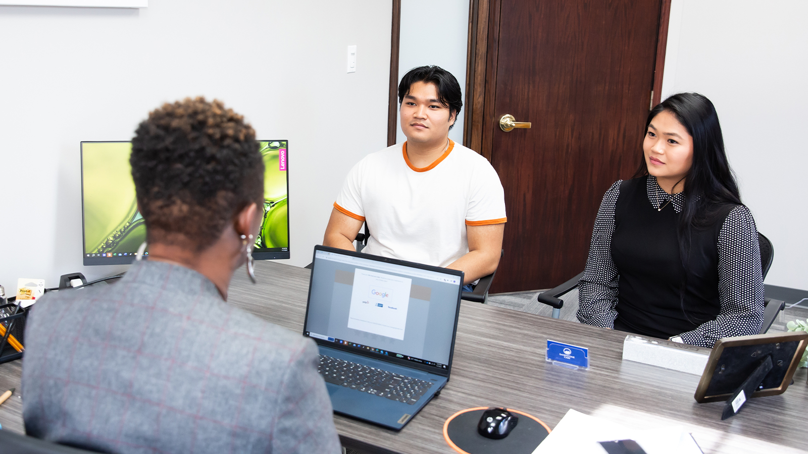 Office space with people at the table.